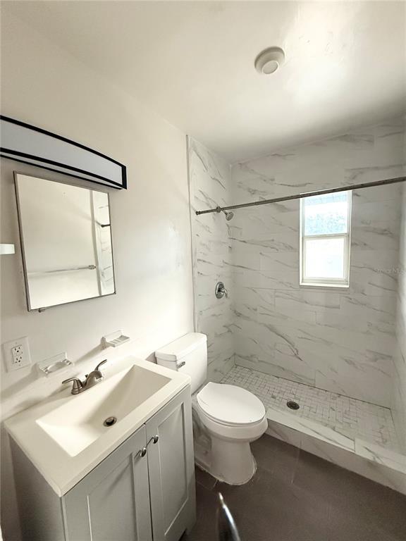 639 Ramona Lane, Unit 6 Orlando, FL 32805 - Photo 11 of 18 a bathroom with a sink mirror and a toilet