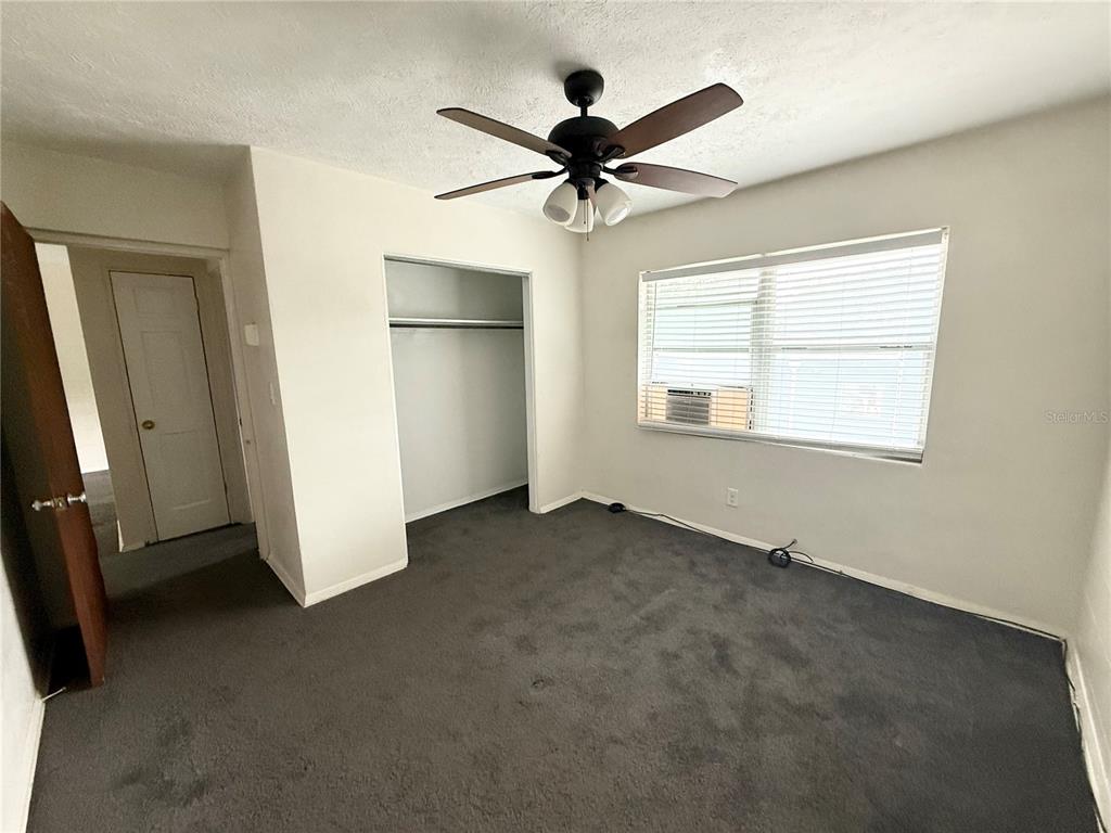 639 Ramona Lane, Unit 6 Orlando, FL 32805 - Photo 14 of 18 an empty room with closet and windows