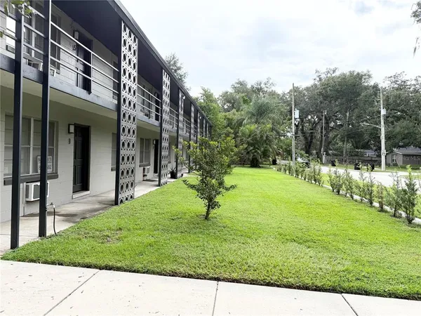 a view of a house with a backyard and a garden