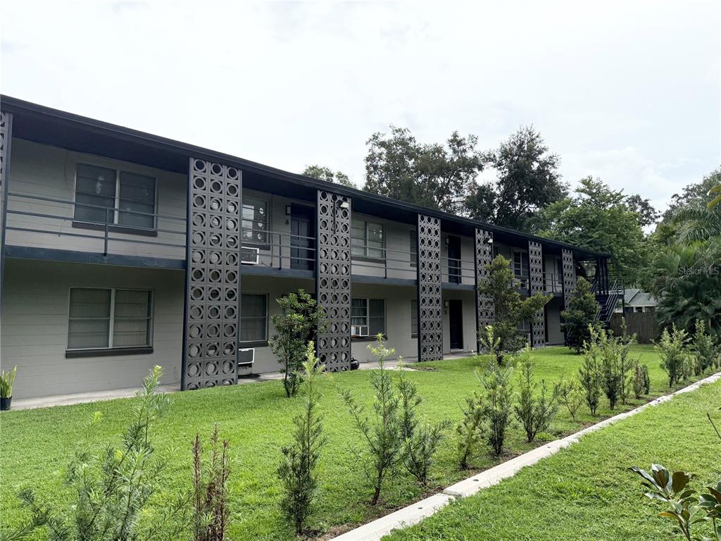 639 Ramona Lane, Unit 6 Orlando, FL 32805 - Photo 17 of 18 a view of a house with brick walls and a yard with plants