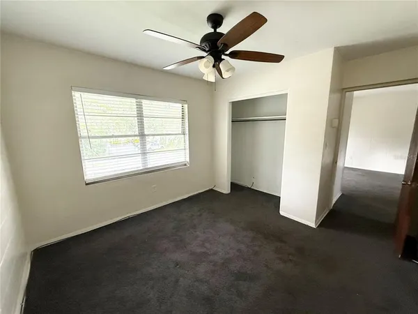 a view of a big room with wooden floor and windows in a room