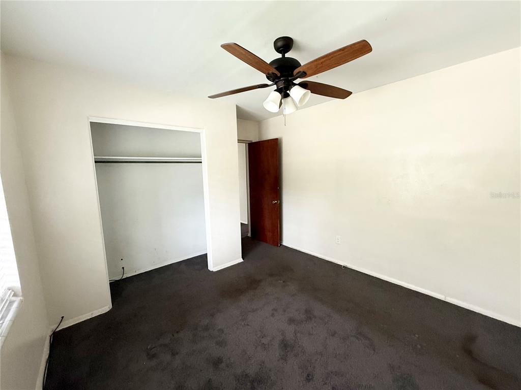 639 Ramona Lane, Unit 6 Orlando, FL 32805 - Photo 10 of 18 a view of a big room with wooden floor and windows in a room