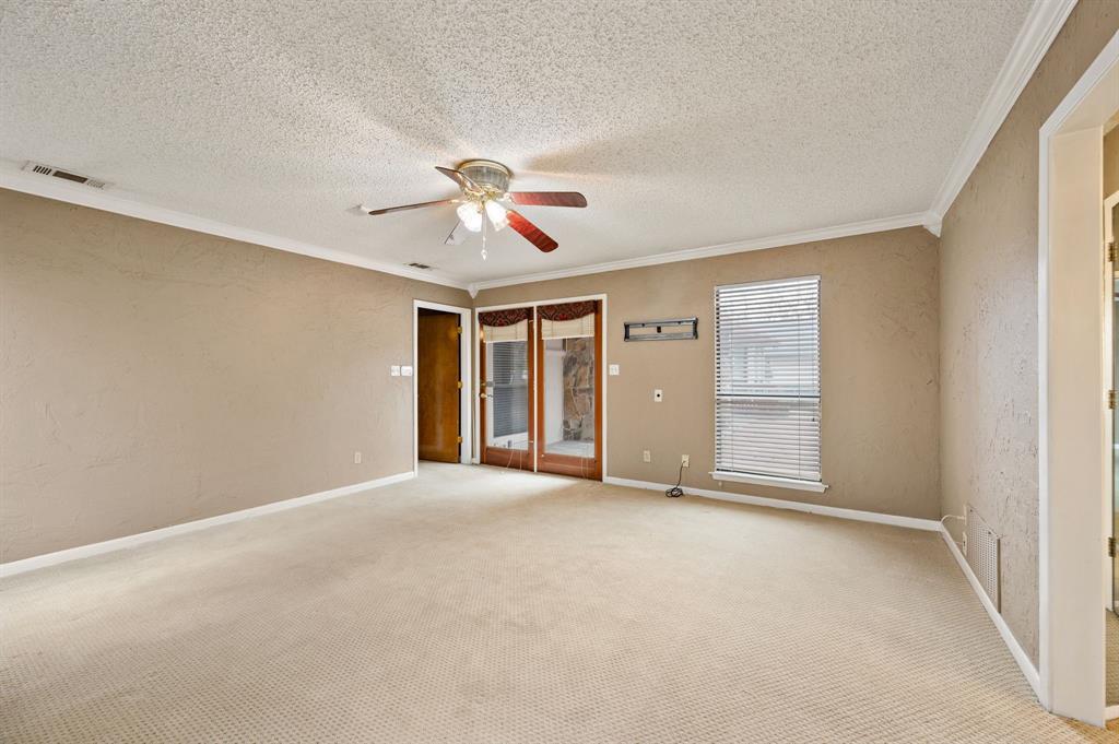 7260 Hudson Cemetery Road Mansfield, TX 76063 - Photo 22 of 40 Spacious room with neutral-toned walls, crown molding, and light-colored carpet