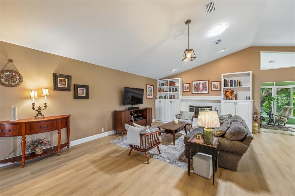 3757 Countryside Road Sarasota, FL 34233 - Photo 6 of 34 a living room with furniture a flat screen tv and a table
