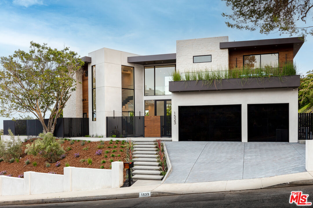 1523 Stradella Road Los Angeles, CA 90077 - Photo 13 of 54 a front view of a house with garage