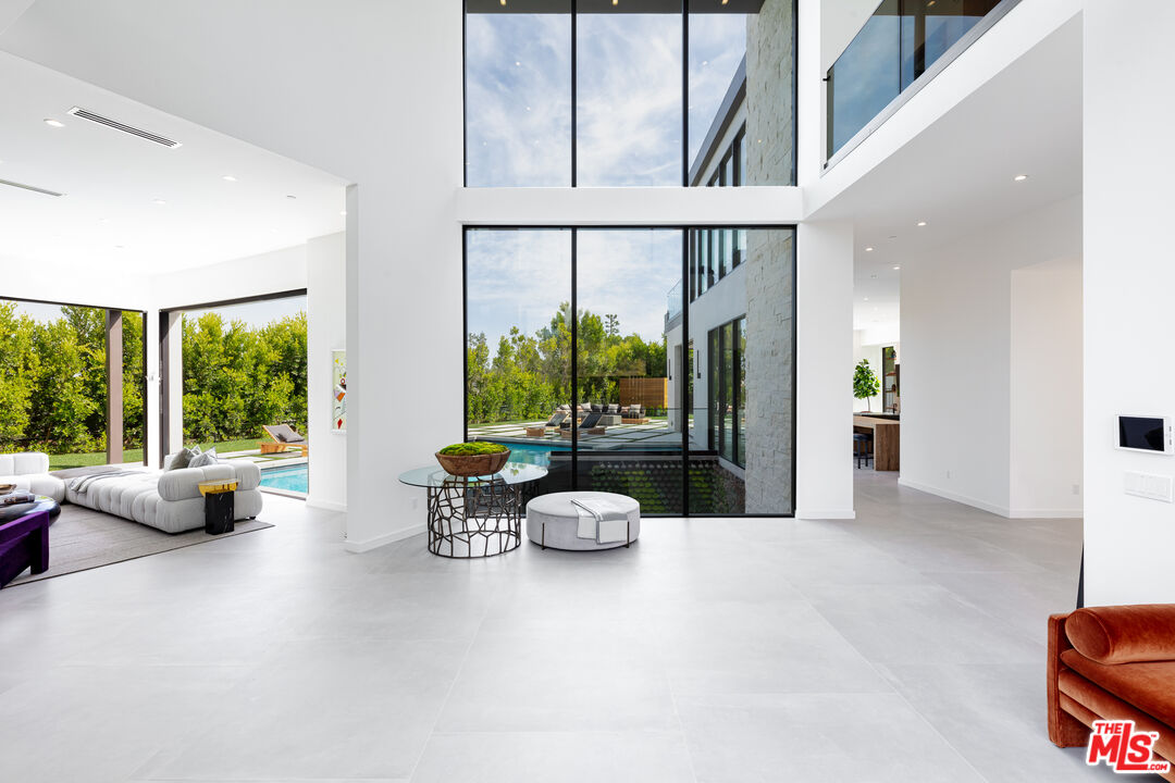 1523 Stradella Road Los Angeles, CA 90077 - Photo 15 of 54 a living room with furniture and floor to ceiling windows