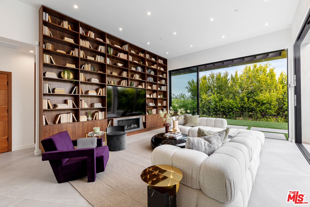 1523 Stradella Road Los Angeles, CA 90077 - Photo 17 of 54 a living room with furniture tv and a large window