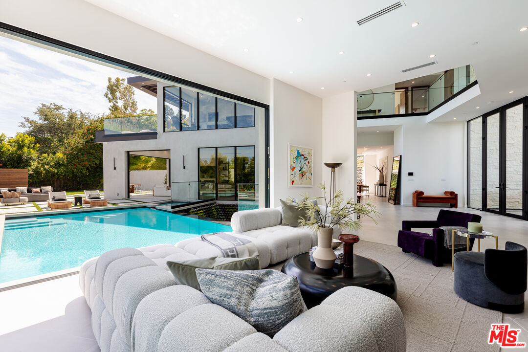 1523 Stradella Road Los Angeles, CA 90077 - Photo 19 of 54 a living room with furniture and a large window