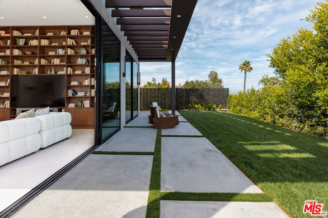 1523 Stradella Road Los Angeles, CA 90077 - Photo 20 of 54 a living room with patio furniture and a garden
