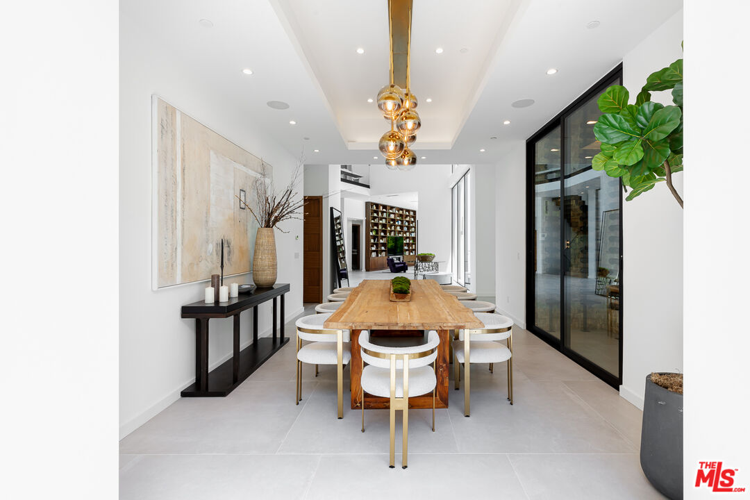 1523 Stradella Road Los Angeles, CA 90077 - Photo 26 of 54 a view of a dining room with furniture and a potted plant