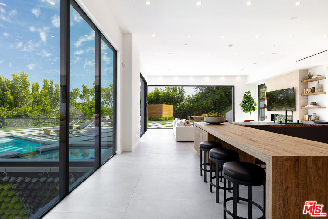 1523 Stradella Road Los Angeles, CA 90077 - Photo 28 of 54 a view of a patio with a table chairs and a patio
