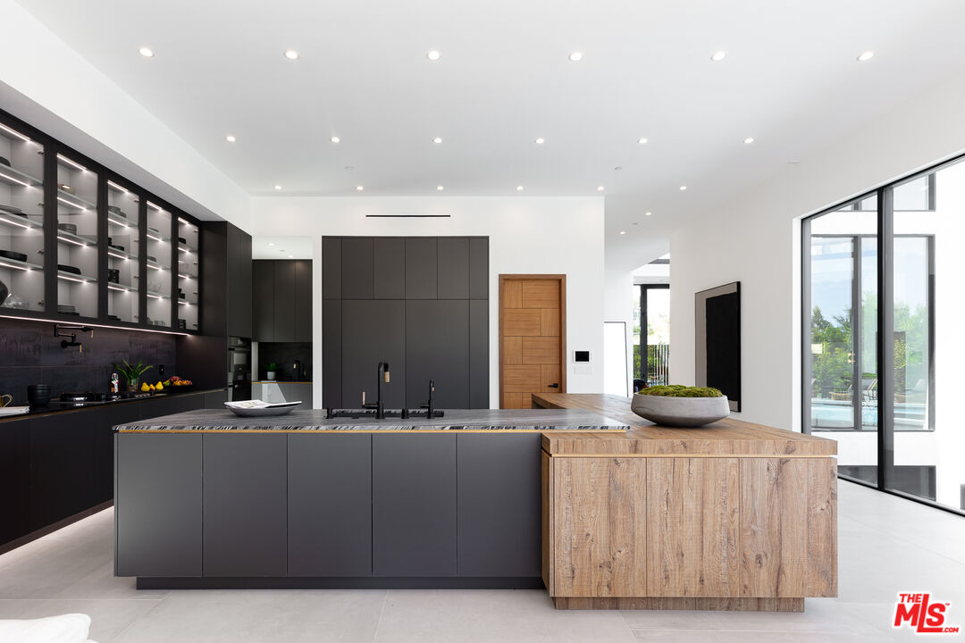 1523 Stradella Road Los Angeles, CA 90077 - Photo 31 of 54 a living room with stainless steel appliances kitchen island furniture and a kitchen view
