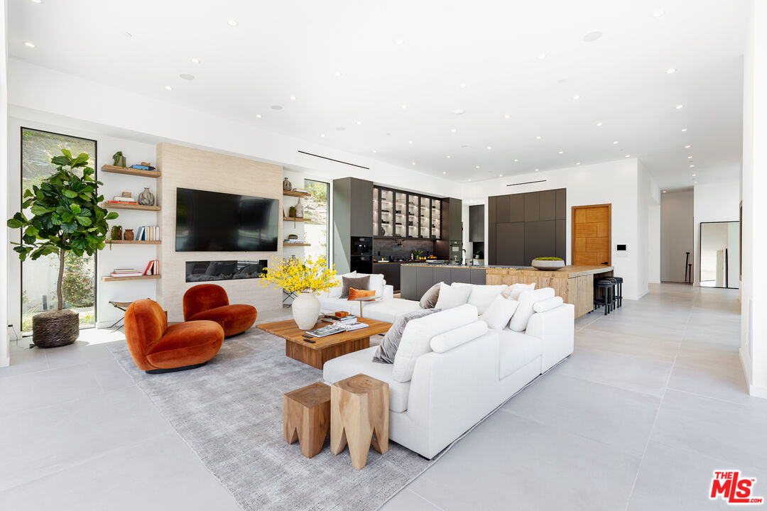 1523 Stradella Road Los Angeles, CA 90077 - Photo 35 of 54 a living room with furniture and a flat screen tv