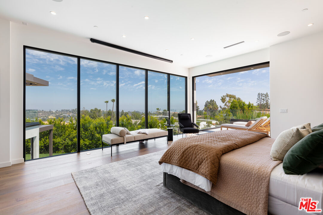 1523 Stradella Road Los Angeles, CA 90077 - Photo 39 of 54 a bedroom with a bed and glass window
