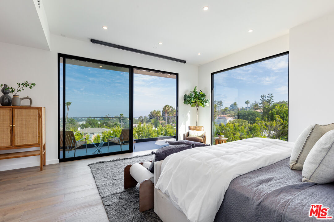 1523 Stradella Road Los Angeles, CA 90077 - Photo 45 of 54 a bedroom with a large window and a bed