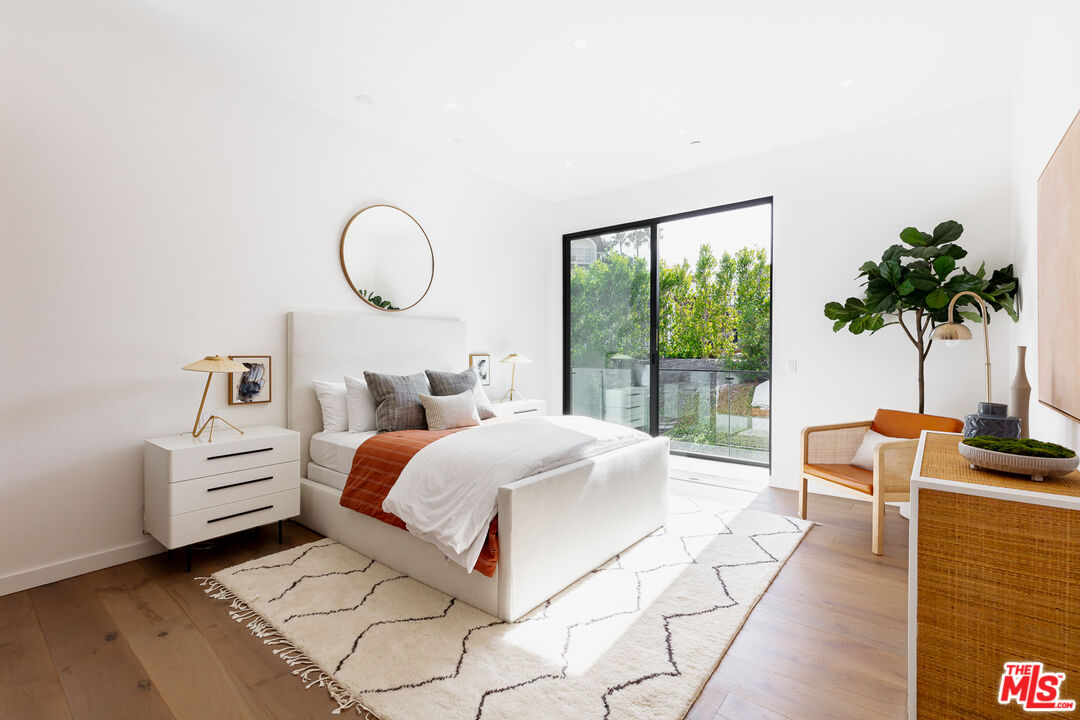 1523 Stradella Road Los Angeles, CA 90077 - Photo 47 of 54 a bed room with a bed and a potted plant