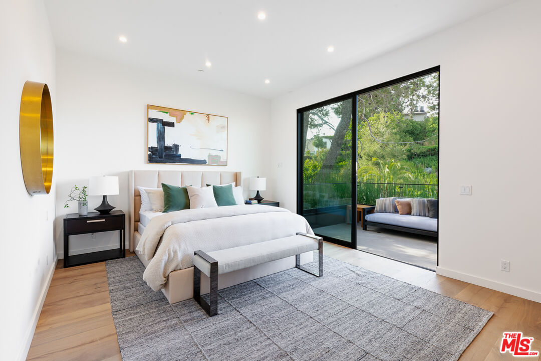 1523 Stradella Road Los Angeles, CA 90077 - Photo 48 of 54 a bedroom with a bed and wooden floor