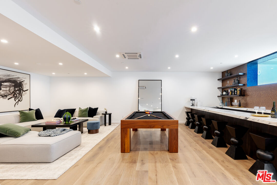 1523 Stradella Road Los Angeles, CA 90077 - Photo 50 of 54 a living room with furniture and a wooden floor