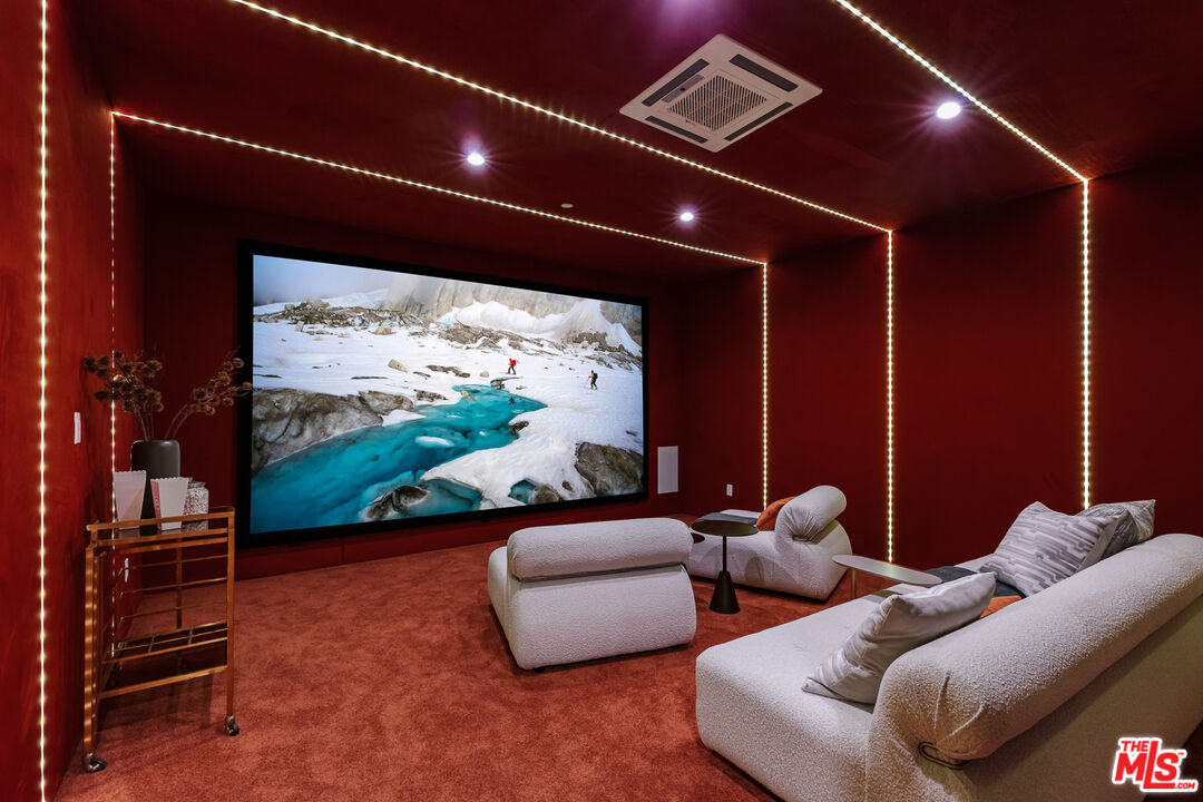 1523 Stradella Road Los Angeles, CA 90077 - Photo 52 of 54 a media room with lots of chairs and a projector