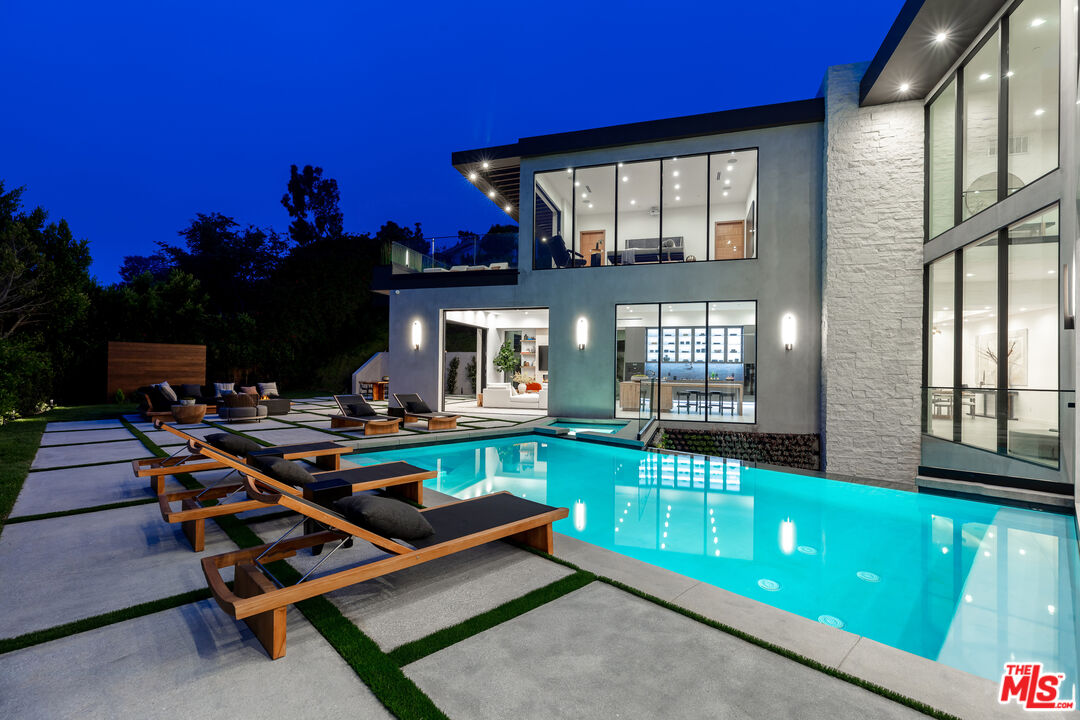 1523 Stradella Road Los Angeles, CA 90077 - Photo 7 of 54 a view of a house with lounge chairs in patio