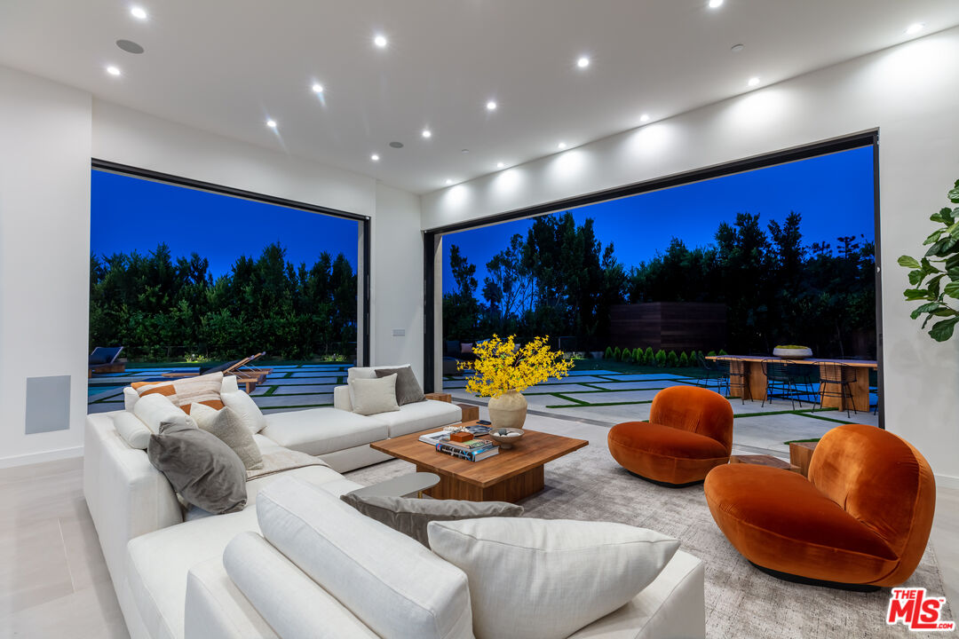 1523 Stradella Road Los Angeles, CA 90077 - Photo 9 of 54 a living room with furniture and a flat screen tv