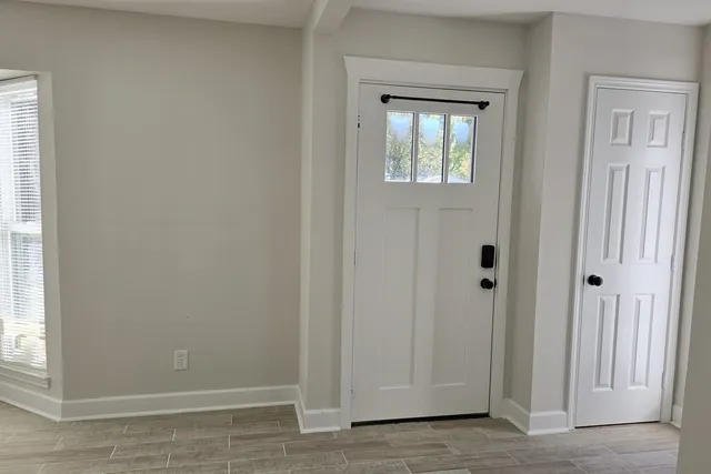 an empty room with windows and closet