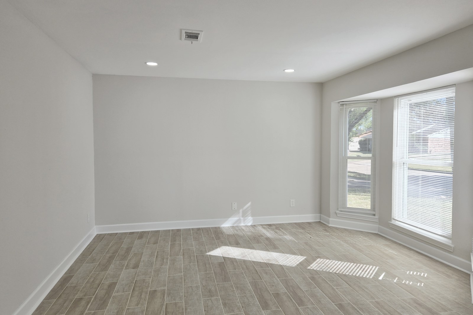 8822 Rowan Lane Houston, TX 77036 - Photo 3 of 12 a view of empty room with wooden floor and fan