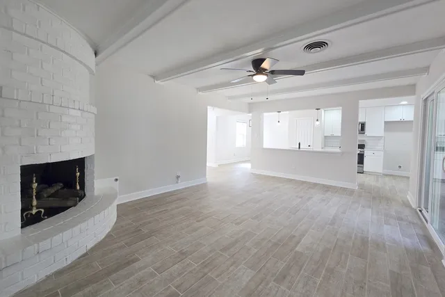 a view of an empty room and fire place