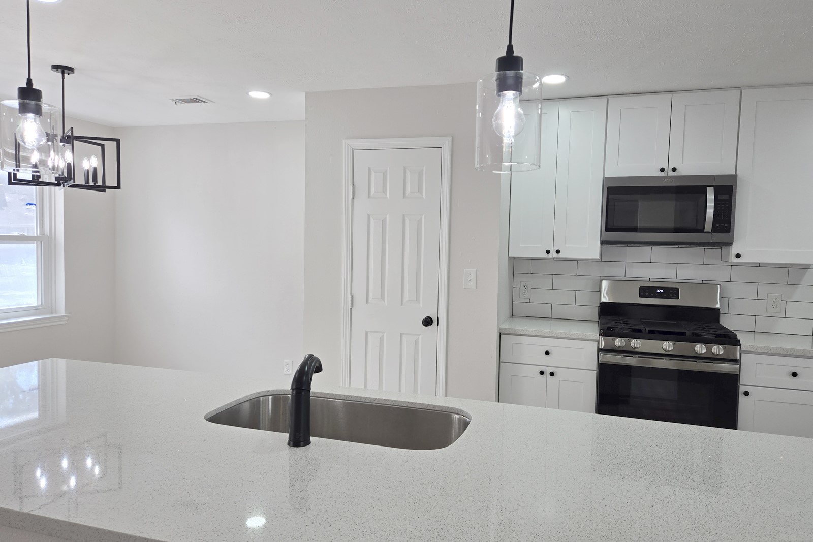 8822 Rowan Lane Houston, TX 77036 - Photo 5 of 12 a kitchen with stainless steel appliances a sink a stove and microwave