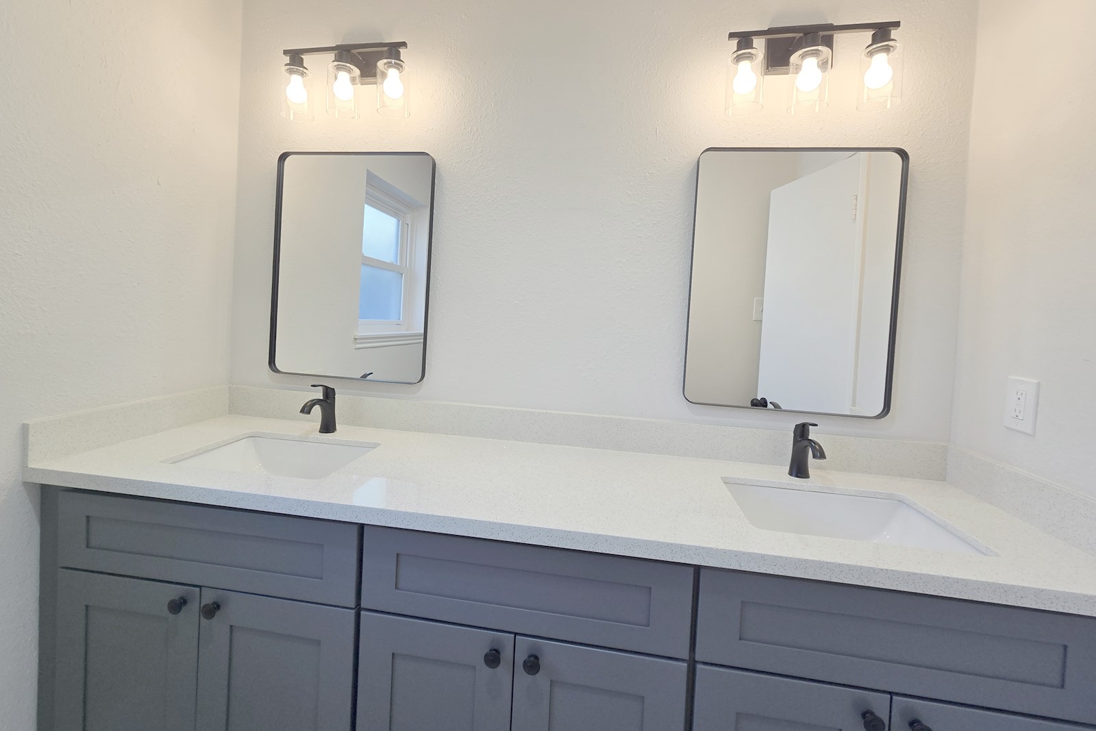 8822 Rowan Lane Houston, TX 77036 - Photo 9 of 12 a bathroom with double vanity sinks and a mirror
