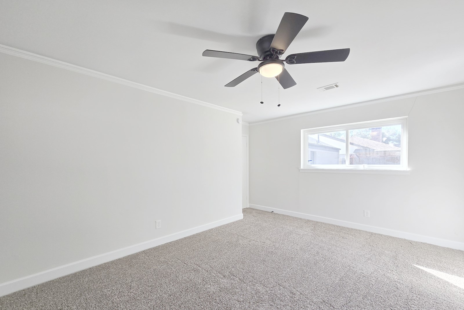 8822 Rowan Lane Houston, TX 77036 - Photo 10 of 12 an empty room with wooden floor and windows