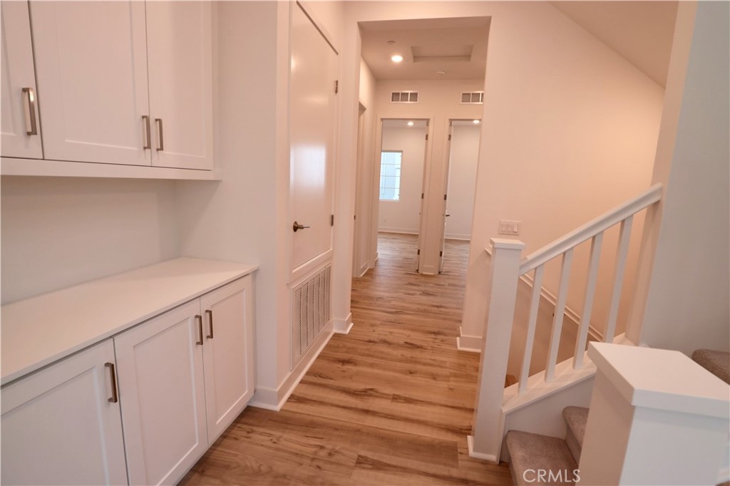 110 Yugen Irvine, CA 92618 - Photo 14 of 28 a view of entryway and hall with wooden floor