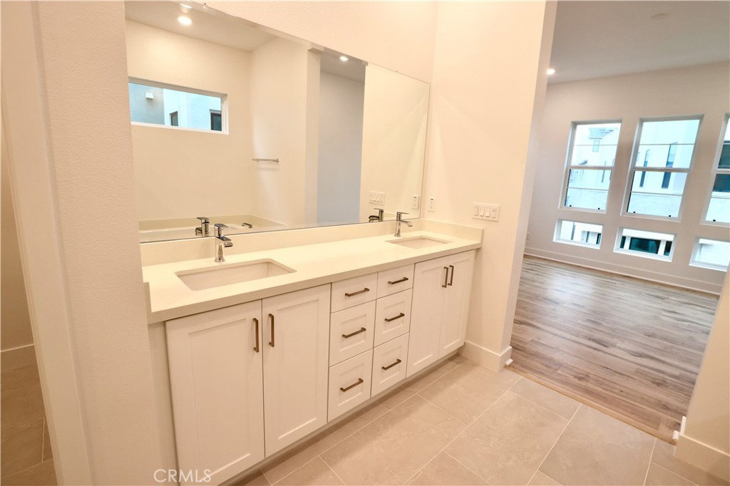 110 Yugen Irvine, CA 92618 - Photo 21 of 28 a bathroom with double sink and a mirror