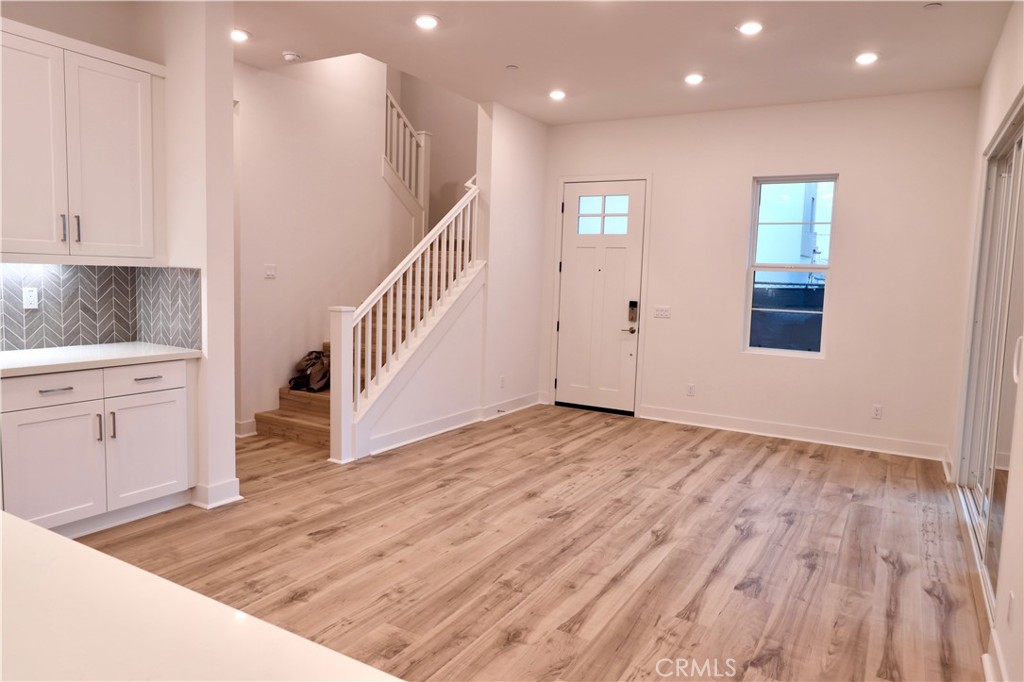110 Yugen Irvine, CA 92618 - Photo 24 of 28 a view of a kitchen cabinets and wooden floor