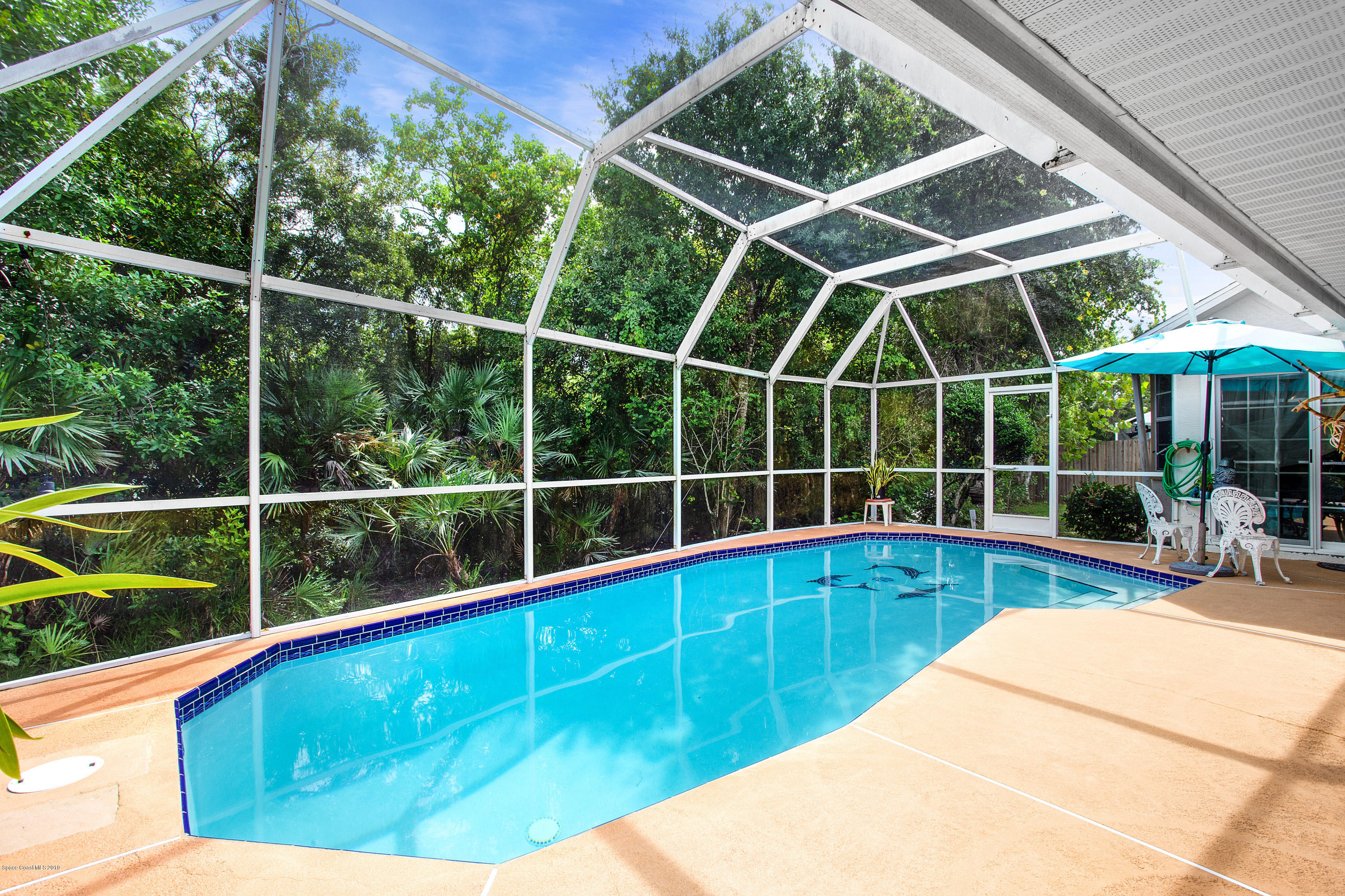 3445 Holly Springs Road Melbourne, FL 32934 - Photo 2 of 28 a view of a backyard with a swimming pool