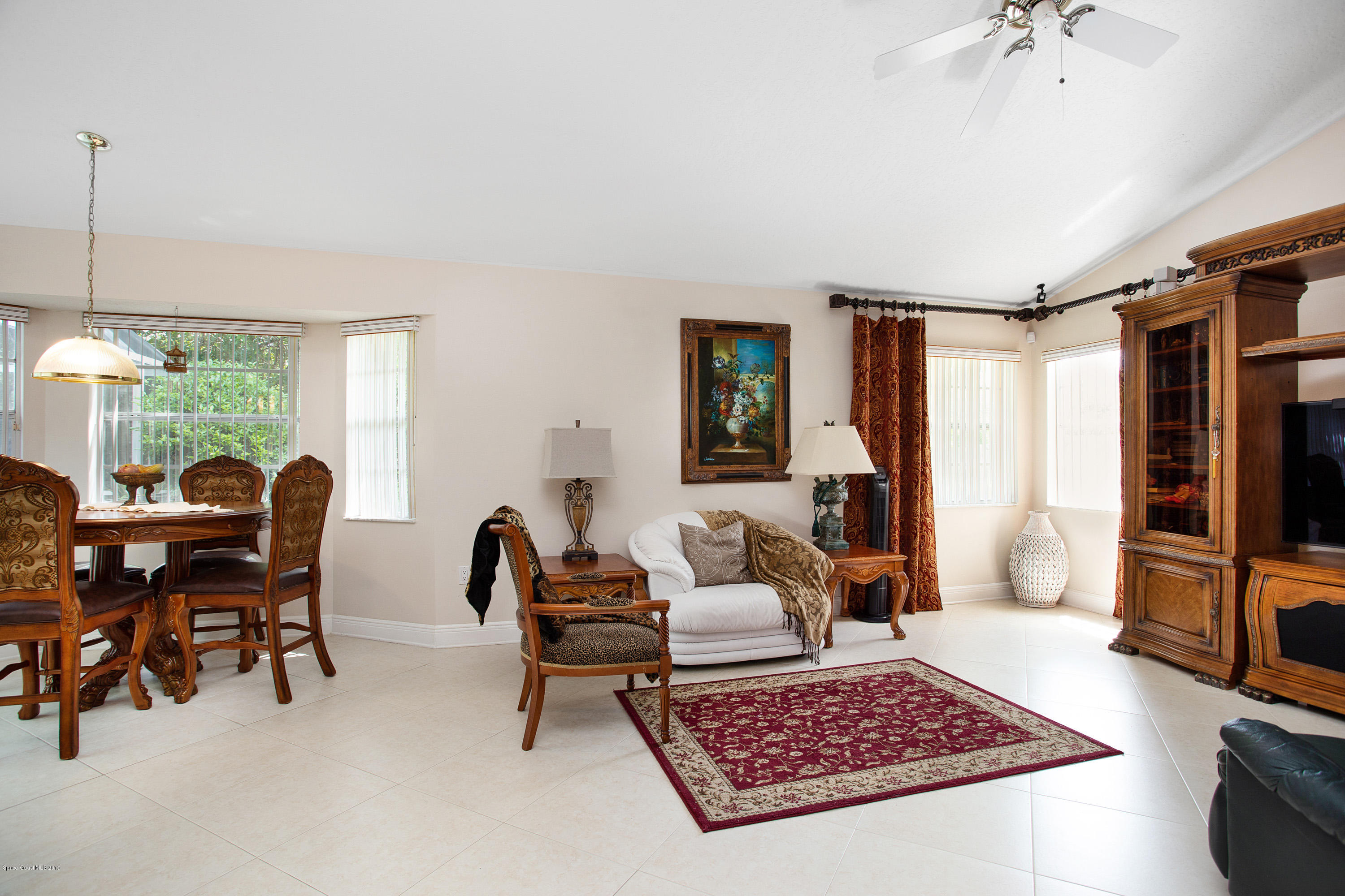 3445 Holly Springs Road Melbourne, FL 32934 - Photo 14 of 28 a living room with furniture and a rug