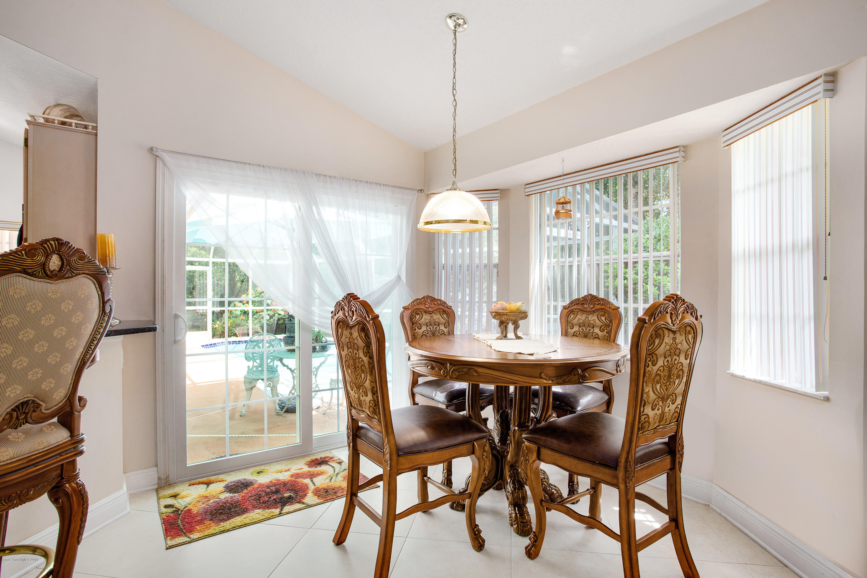 3445 Holly Springs Road Melbourne, FL 32934 - Photo 15 of 28 a view of a dining room with furniture window and outside view