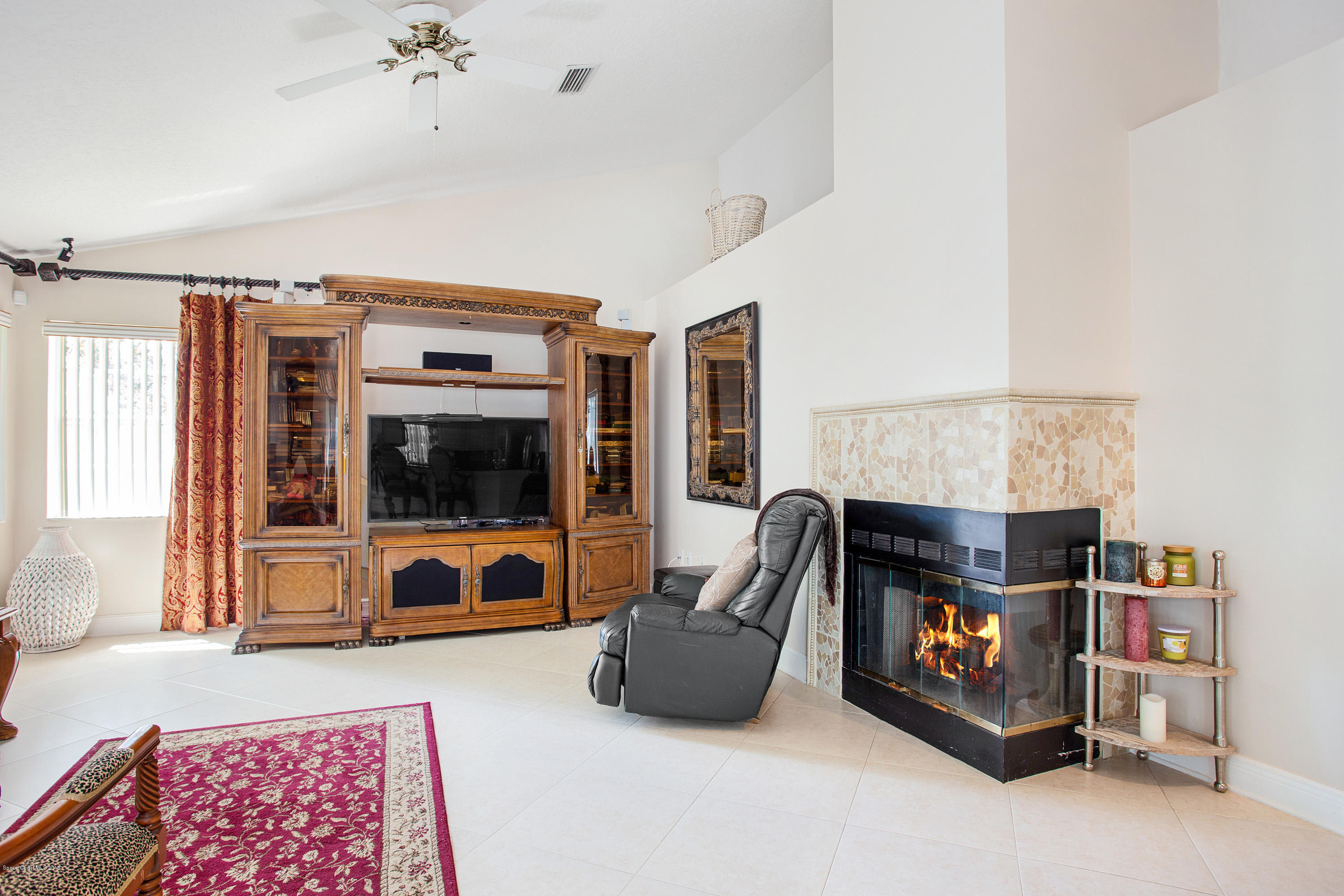 3445 Holly Springs Road Melbourne, FL 32934 - Photo 17 of 28 a living room with furniture and a flat screen tv
