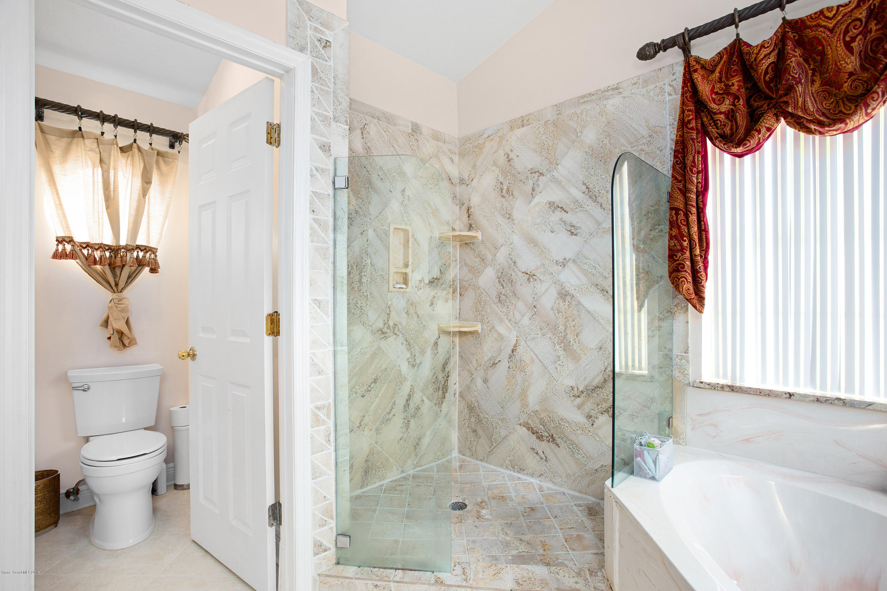 3445 Holly Springs Road Melbourne, FL 32934 - Photo 19 of 28 a bathroom with a toilet and a shower