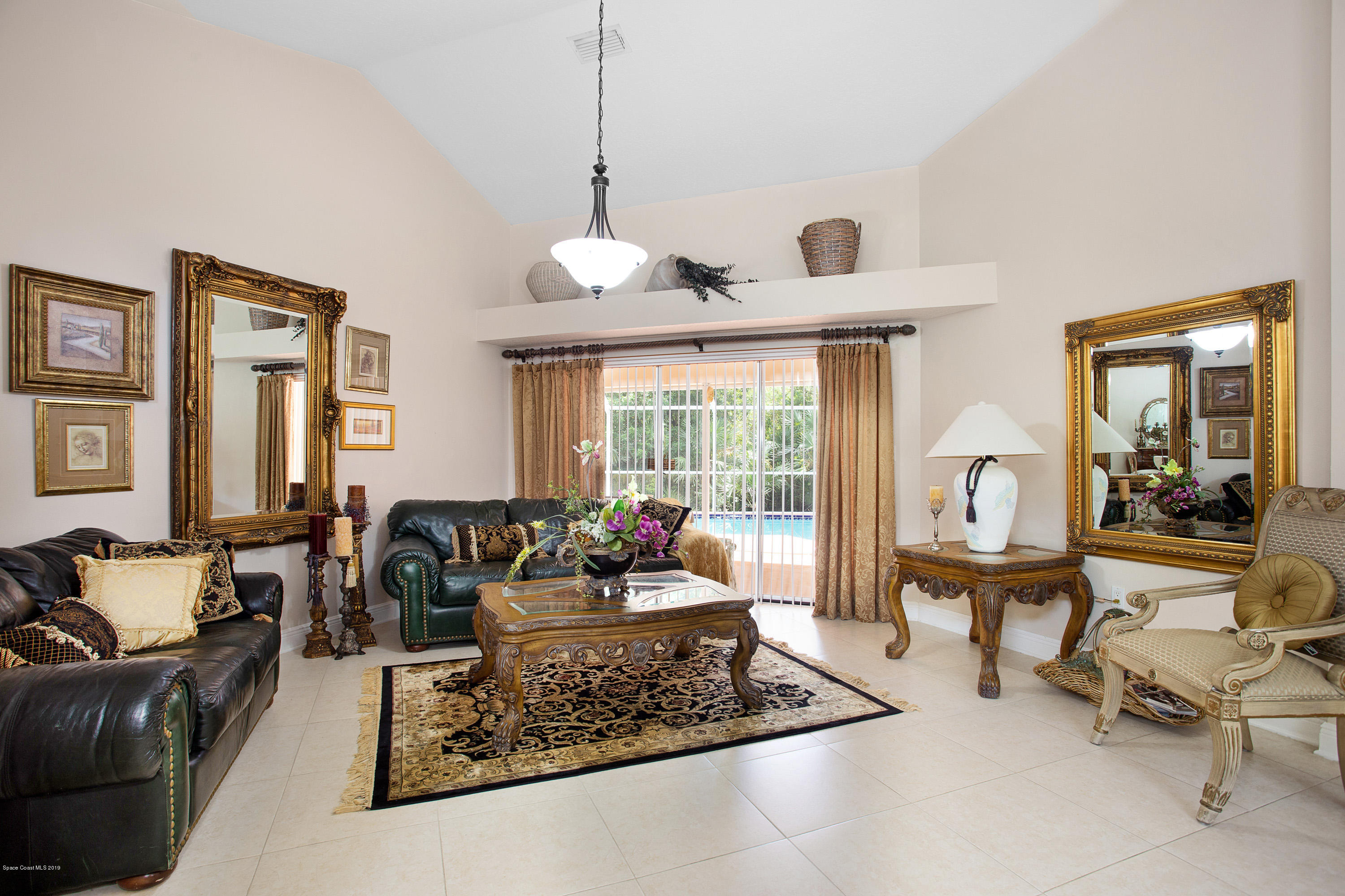 3445 Holly Springs Road Melbourne, FL 32934 - Photo 3 of 28 a living room with furniture