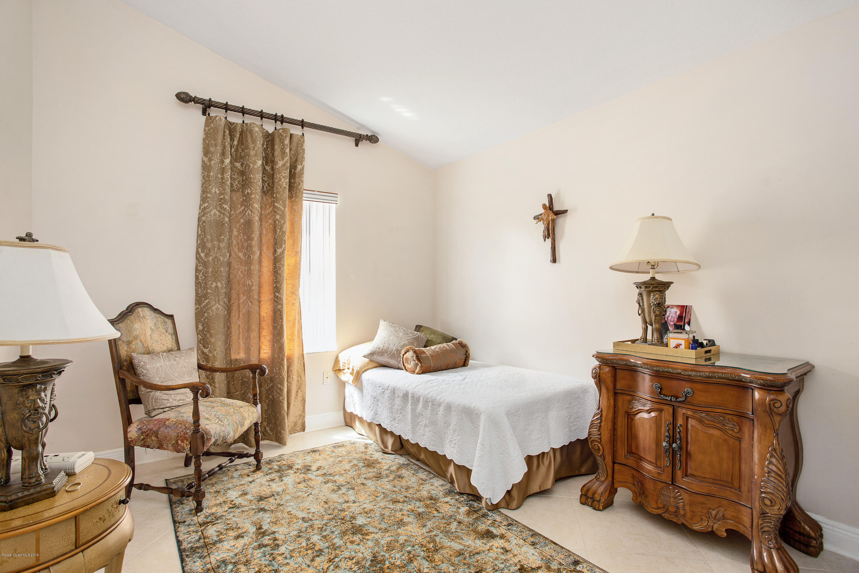 3445 Holly Springs Road Melbourne, FL 32934 - Photo 21 of 28 a bedroom with furniture and a window