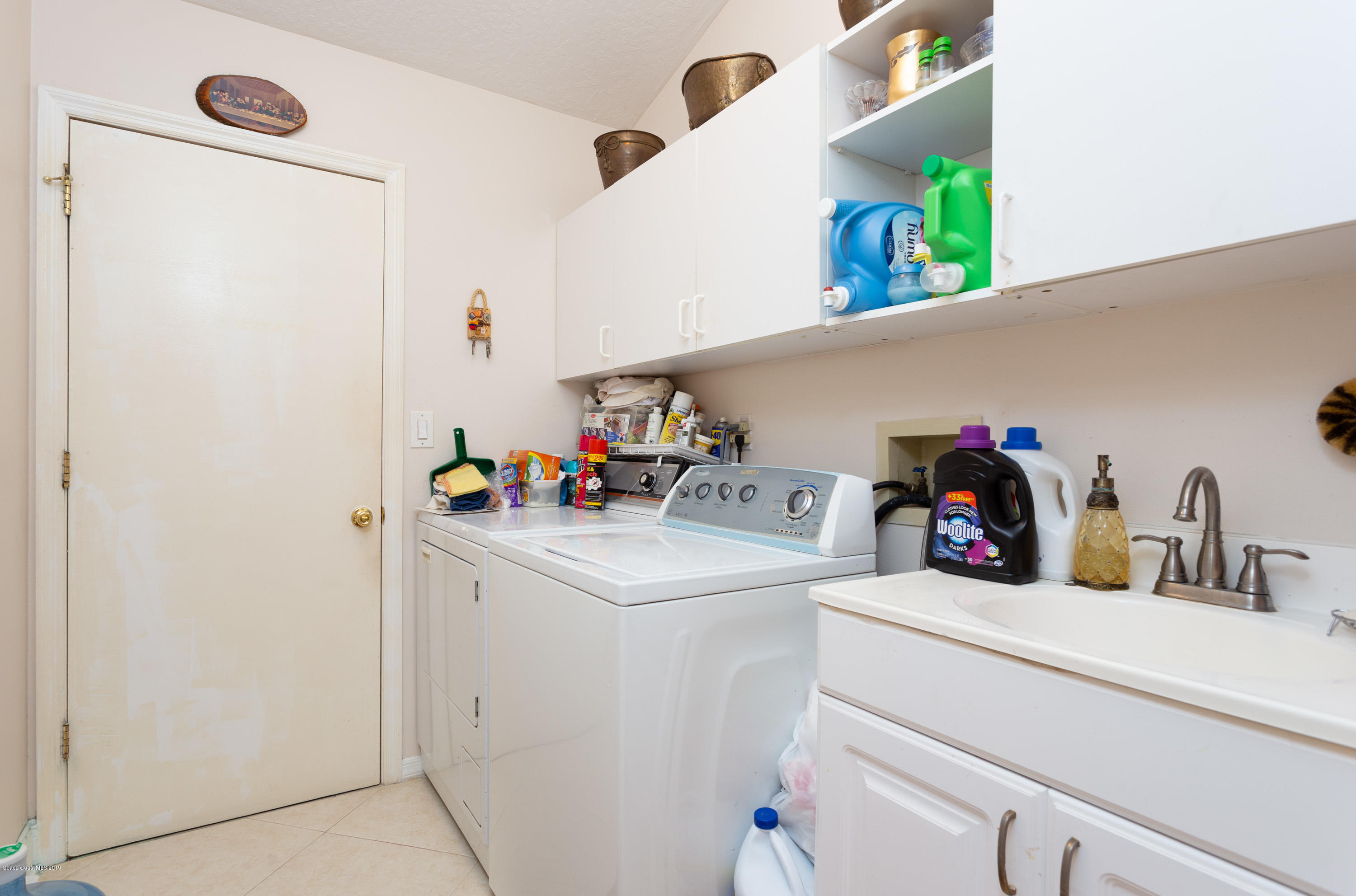 3445 Holly Springs Road Melbourne, FL 32934 - Photo 24 of 28 a utility room with sink dryer and washer