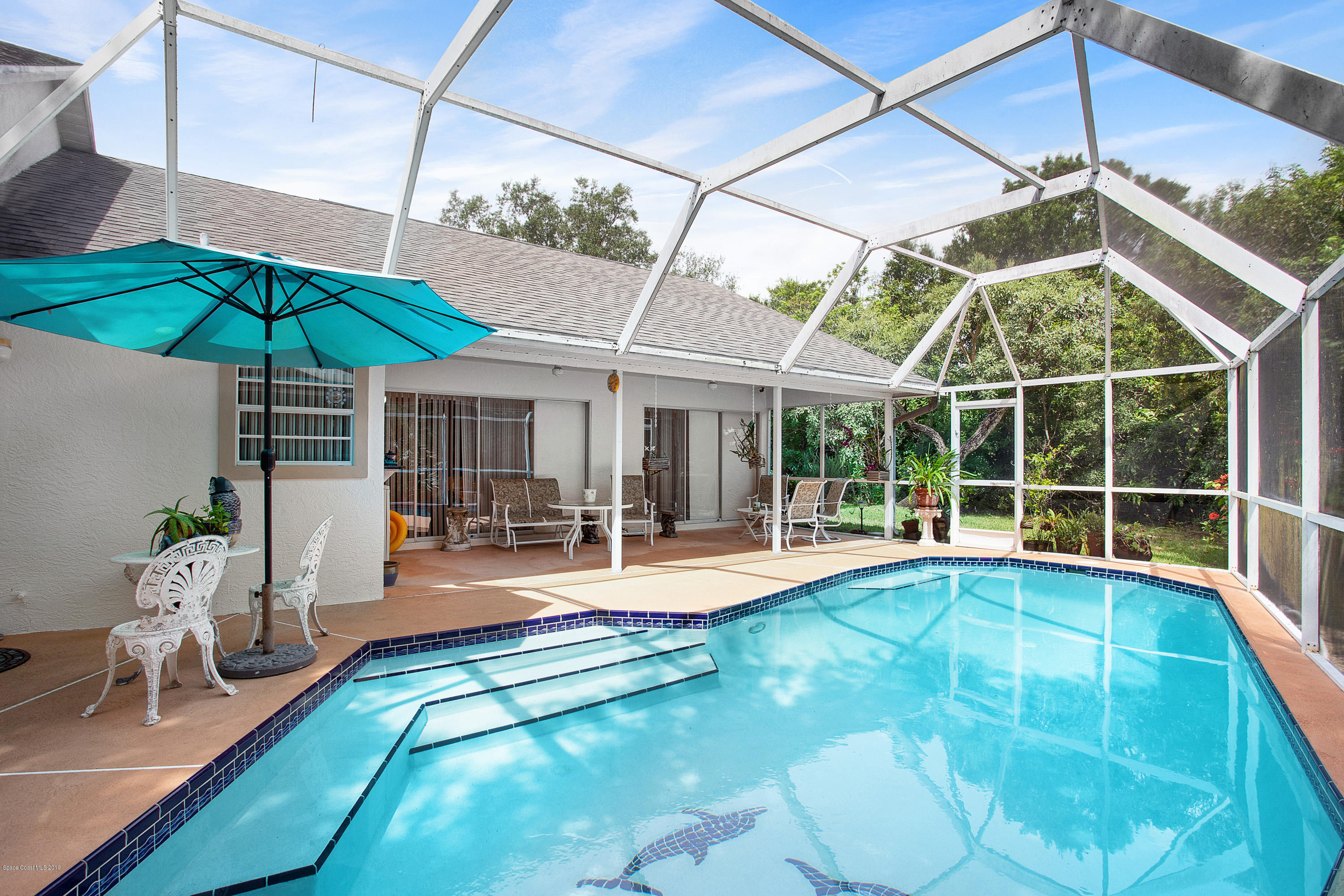 3445 Holly Springs Road Melbourne, FL 32934 - Photo 27 of 28 a view of a house with backyard and sitting area