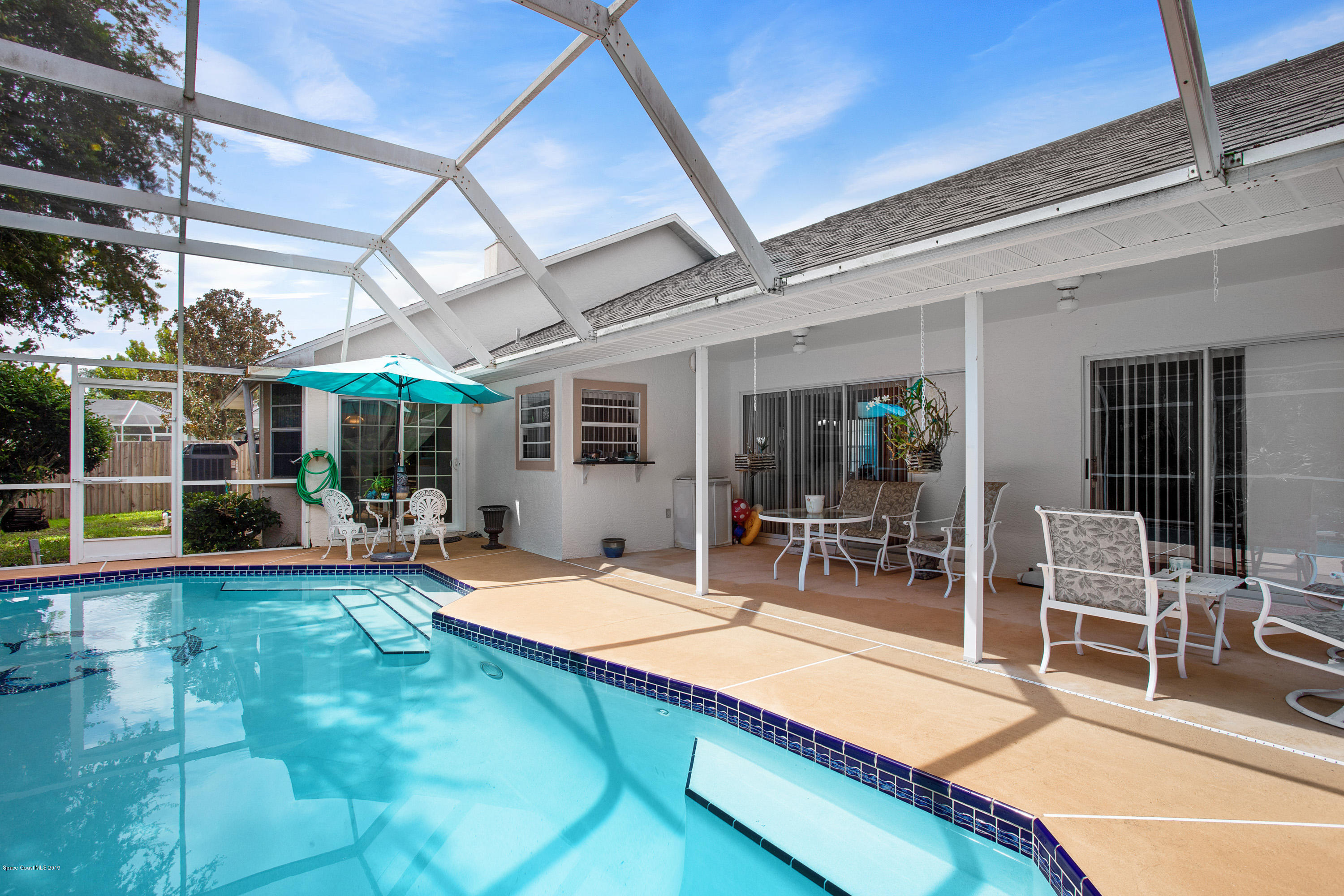 3445 Holly Springs Road Melbourne, FL 32934 - Photo 28 of 28 a outdoor space with swimming pool and furniture