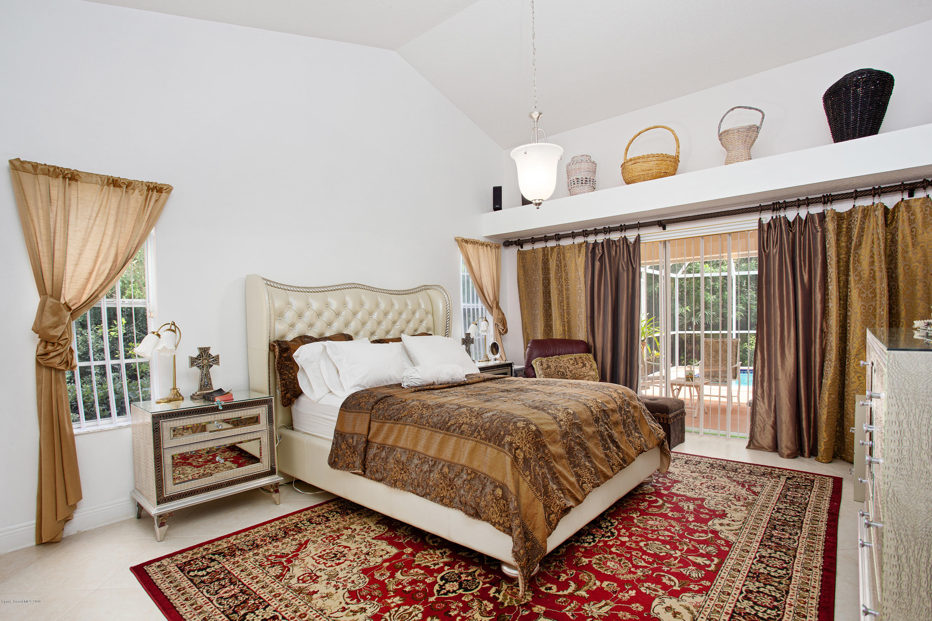 3445 Holly Springs Road Melbourne, FL 32934 - Photo 5 of 28 a bedroom with a bed and a window