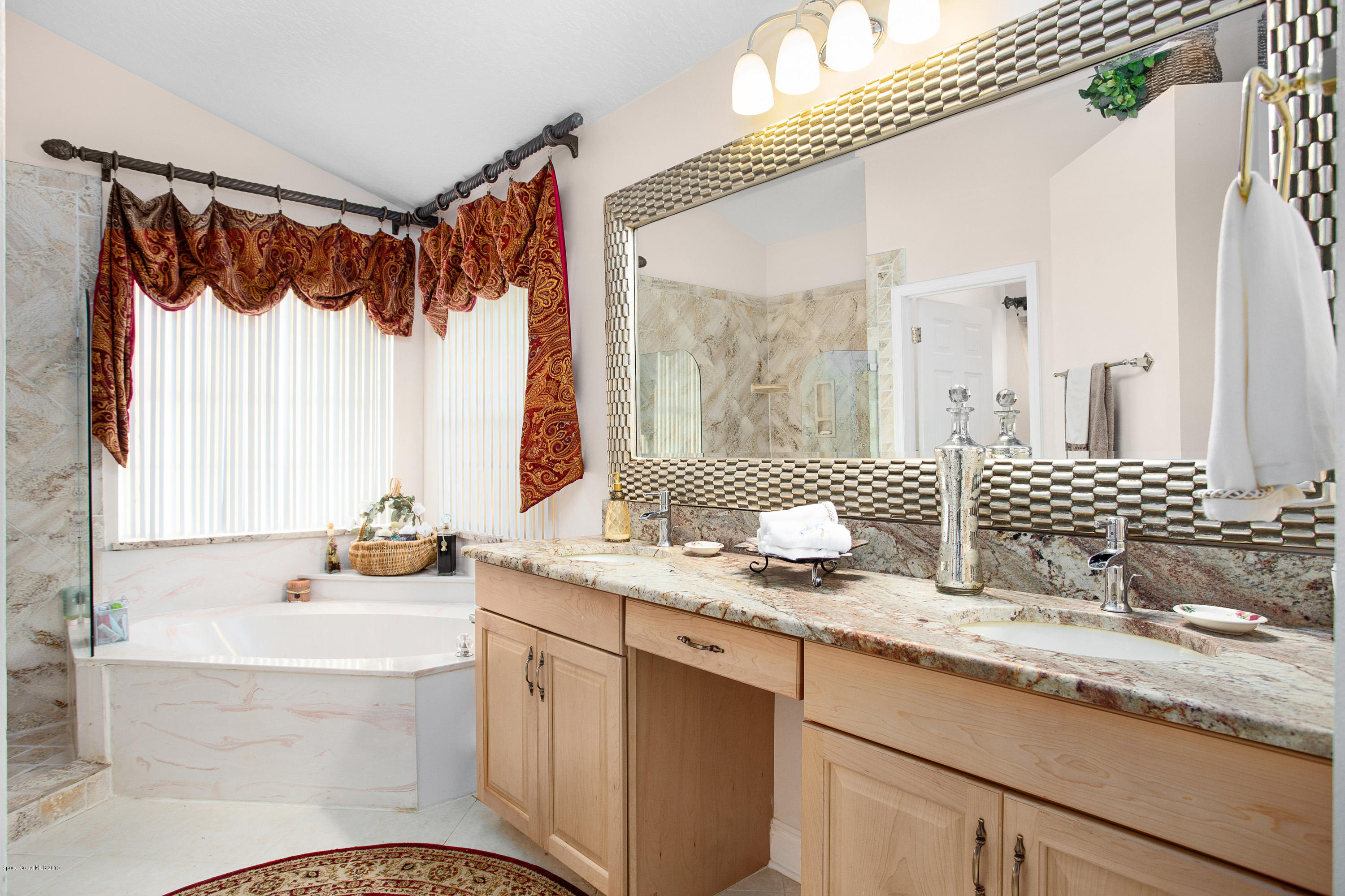 3445 Holly Springs Road Melbourne, FL 32934 - Photo 6 of 28 a bathroom with a granite countertop sink and a mirror
