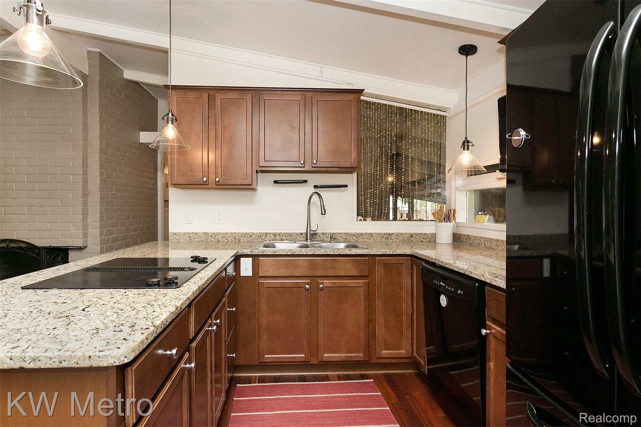 3216 West Webster Road Royal Oak, MI 48073 - Photo 12 of 35 Wonderfully updated kitchen with matching wood floors.