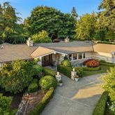 an aerial view of a house with swimming pool and garden