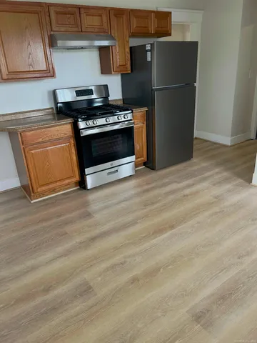 a kitchen with a stove and a refrigerator