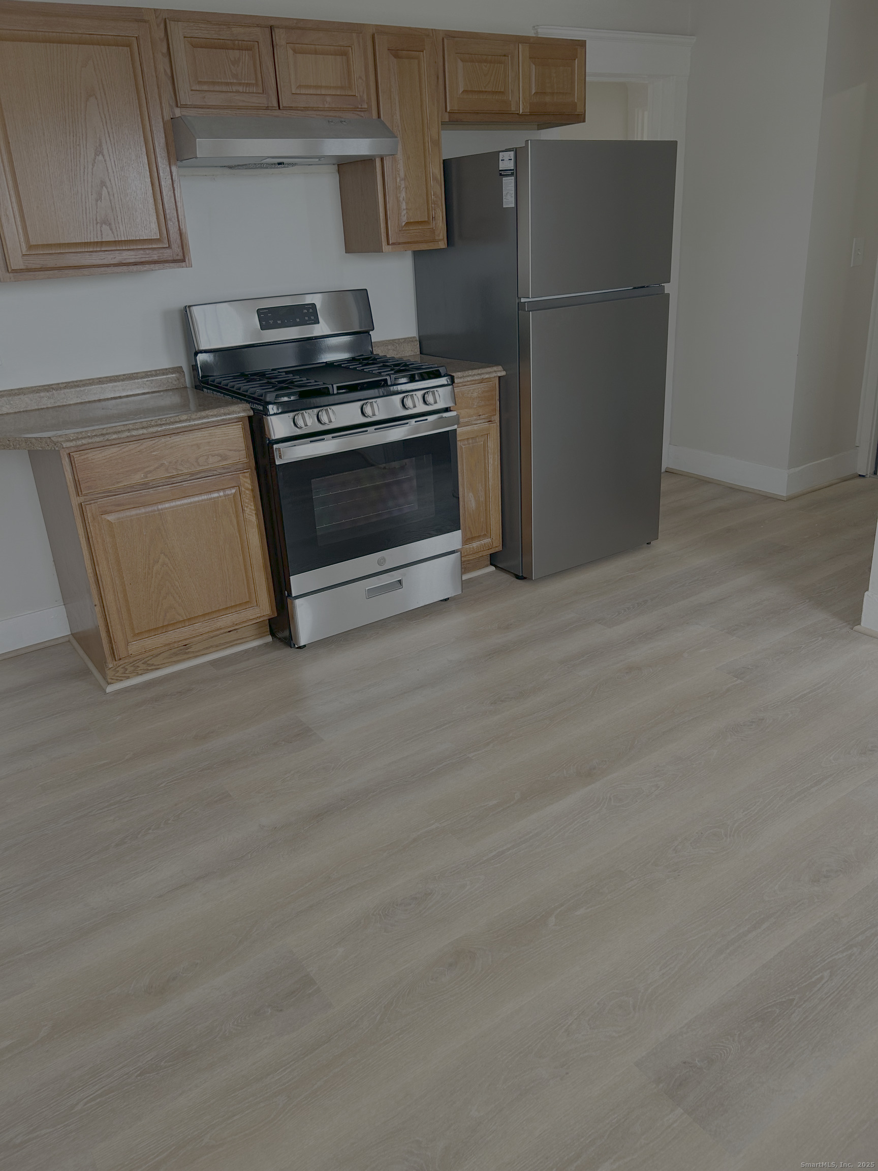 64 Lexington Street Hamden, CT 06514 - Photo 2 of 6 a kitchen with a stove and a refrigerator
